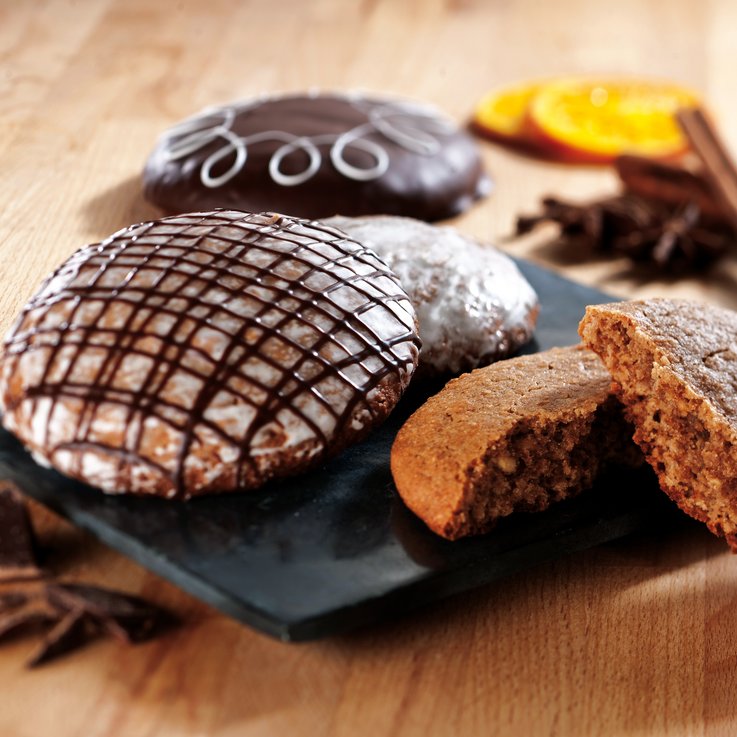 Gingerbread with chocolate coating and a sliced piece.